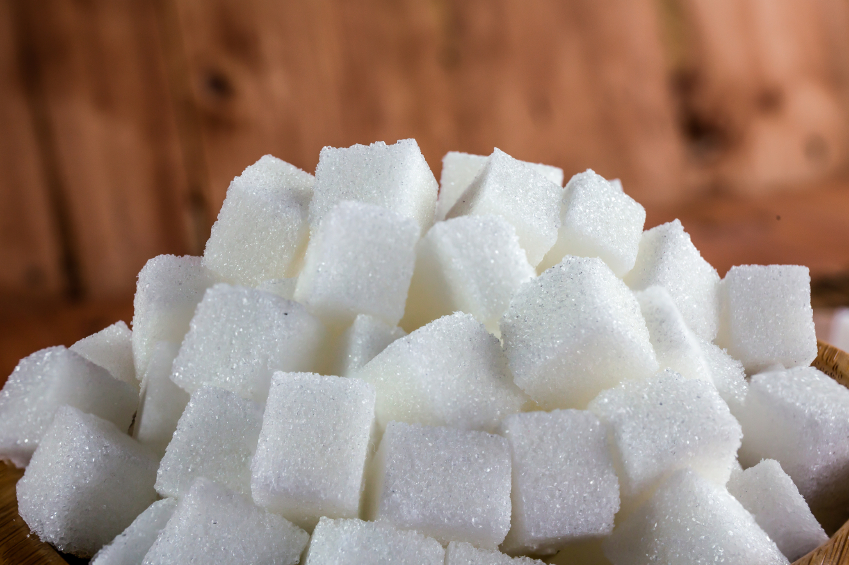 Pile of Sugar Cubes over Wooden Background